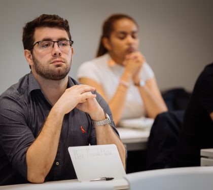 master in supply chain student listening in class