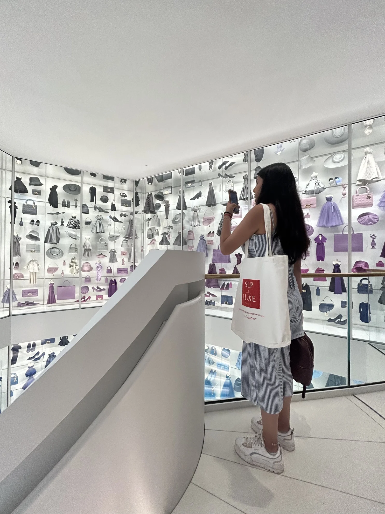 student taking picture in a luxury fashion brand store